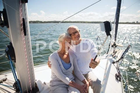 Senior couple taking selfie on sail boat or yacht Stock Photos