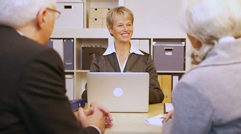 Senior couple talking to consultant Stock Footage 34372253