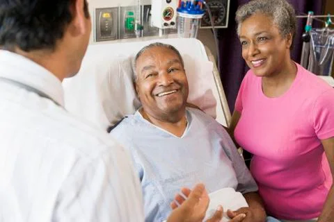 Senior Couple Talking,Smiling With Doctor Stock Photos