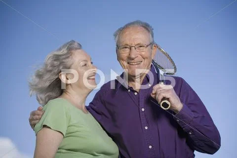 A senior couple with a tennis racket Stock Photos
