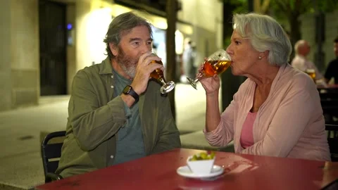 Senior couple toasting at camera enjoying evening in the city Stock Footage 291620092