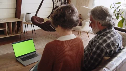 Senior couple using computer laptop for internet searching, online shopping Stock Footage 244119242