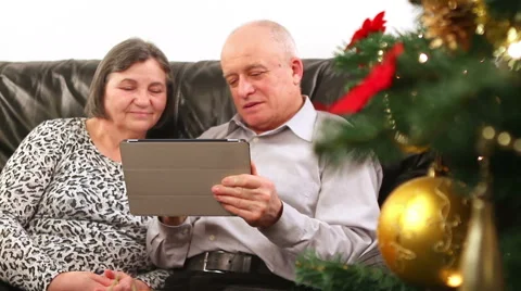 Senior couple using digital tablet at Christmas 3 Stock Footage 52015829