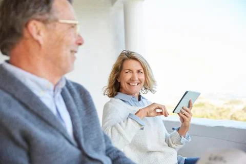 Senior couple using digital tablet on patio Stock Photos
