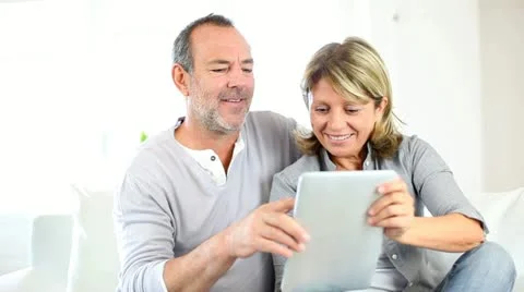 Senior couple using electronic tablet at home Stock-Footage 14829940
