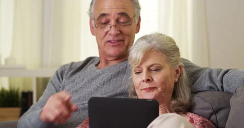 Senior couple using tablet on couch Stock-Footage 47628388