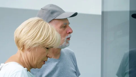 Senior couple using touchscreen. Female making gestures by touching screen Stock-Footage 94623688