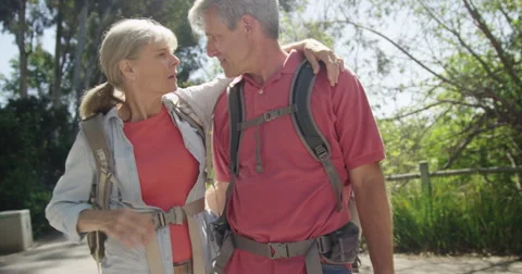Senior couple walking and talking on trail Stock Footage
