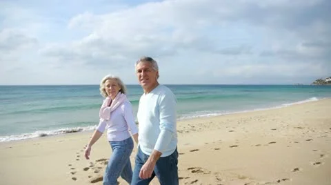 Senior couple walking by the beach Stock Footage 14824647