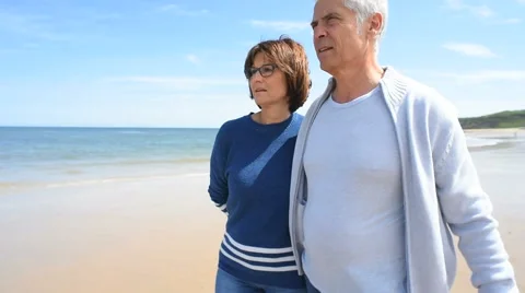 Senior couple walking on the beach Stock Footage 63990230
