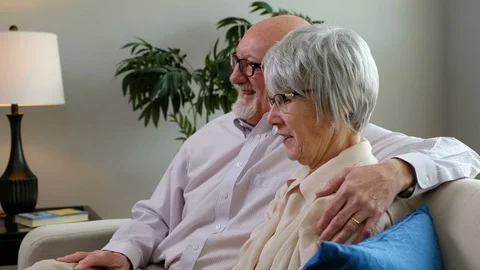 Senior couple watching a program and laughing Video stock 107625839