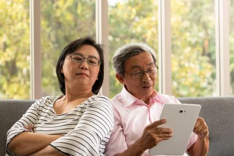 Senior couples relax on holiday with modern technologe Stock Photos