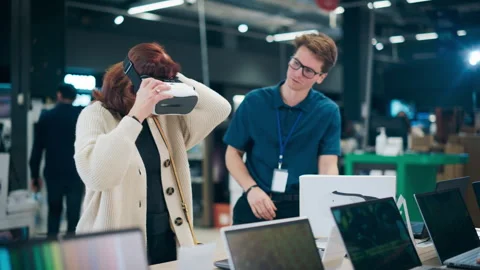 Senior Customer Trying Out Virtual Reality Headset in Store Stock Footage 243830580