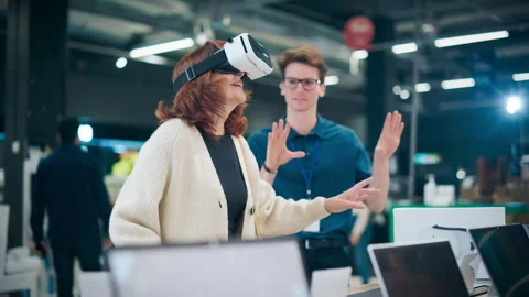 Senior Customer Trying Out Virtual Reality Headset in Store Stock Footage 243830647
