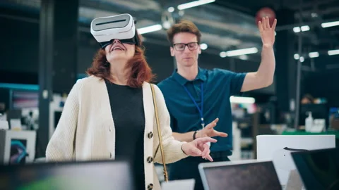 Senior Customer Trying Out Virtual Reality Headset in Store Stock Footage 243830748
