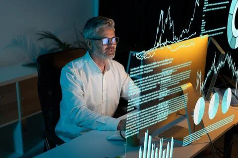 Senior Data Scientist Analyzing Complex Algorithms on Multiple Screens Stock Photos
