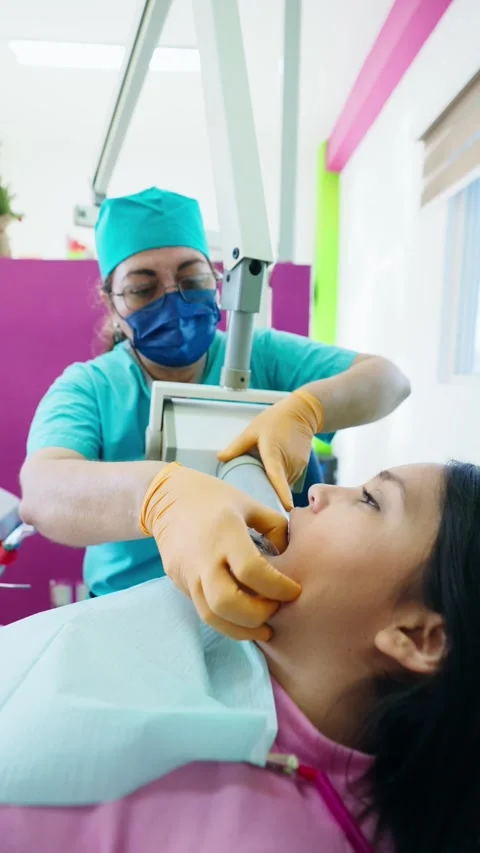 Senior Dentist Performing an X-ray on a Mexican Patient Stock Footage 289148437