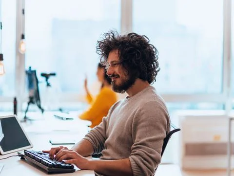 Senior developer fixing bug in fancy office. Stock Photos