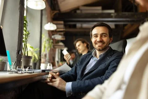 Senior developer. Happy man looking at camera and smilling. Work in modern loft 스톡 사진