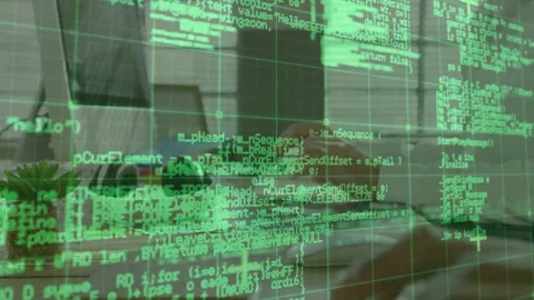 Senior developer typing on keyboard, pairing on code, green grid overlay Stock Footage 333425731