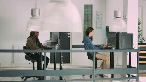 Senior developers coding on laptop in software agency office Stock Footage 221744001