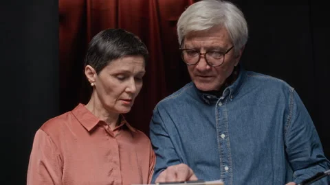 Senior Director Discussing Script with Mature Female Screenwriter Stock Footage 311447065