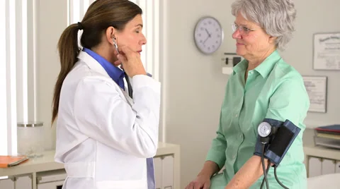 Senior doctor checking elderly patient's blood pressure Stock-Footage 34081341