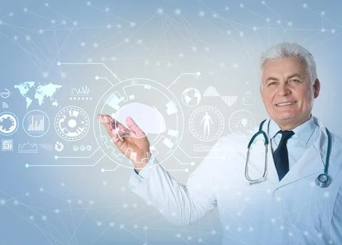 Senior doctor demonstrating machine learning model on light background Stock Photos