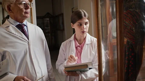 Senior Doctor Explaining Anatomy Specimen to Woman Medical Student Stock Footage 341652479