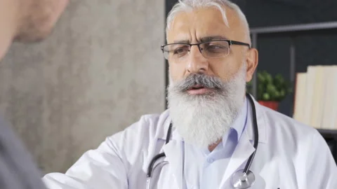 Senior doctor giving bad news to male pa... | Stock Video | Pond5