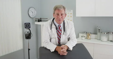 Senior doctor looking at camera smiling Video stock 58338443