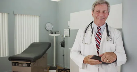 Senior doctor smiling at the camera Video stock 58356416