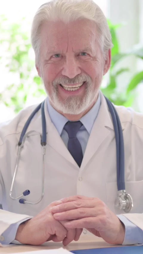 Senior Doctor Smiling at Camera at Work in Clinic, vertical video Video stock 328974884