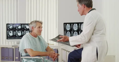 Senior doctor talking with disabled elderly patient Video stock 44815319