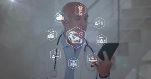 Senior doctor tapping tablet and causing hex icons to form around torso to Stock Footage 330894371