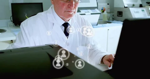 Senior doctor typing lab data showing floating user icons pausing and removing Stock Footage 311417017