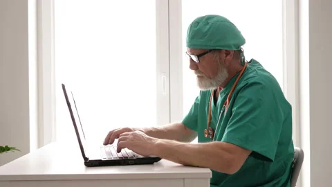 Senior doctor using computer at work. Stock Footage 128985156