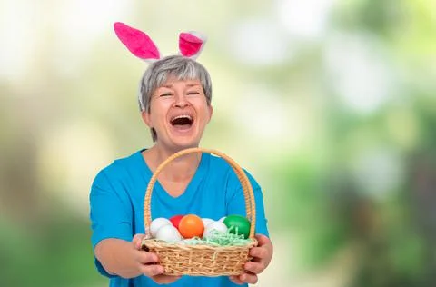 Senior with easter basket isolated Stock Photos