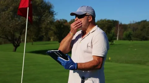 Senior elderly golfer using a tablet to track points during a tournament Stock Footage 292017473