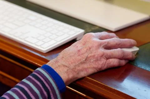 Senior elderly lady's hand on computer mouse Stock Photos