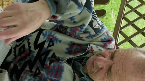 Senior elderly man eats and drinks tea on patio Stock Footage 91165653