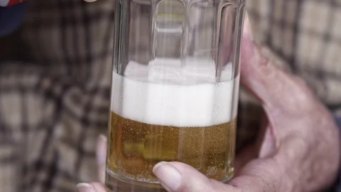 Senior Elderly Man, pouring beer in to glass, Close up Slow Motion Video Видео 105973745
