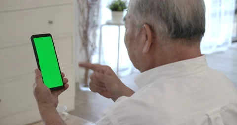 Senior elderly man using smartphone with green screen for video calling. Video stock 153250823