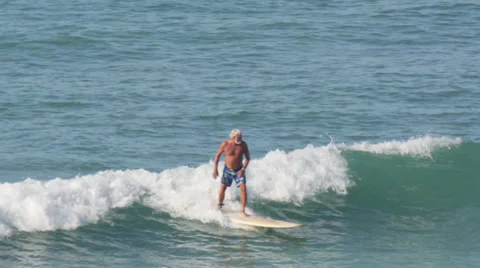 Senior elderly old man Surfer surfing in Waikiki beach Hawaii Stock Footage