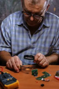Senior electrician checking chips Stock Photos