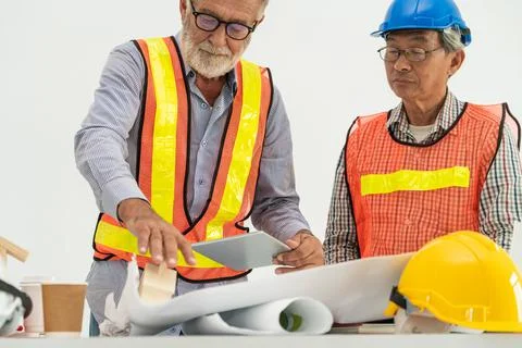 Senior engineer and architect working with drawing Fotos de archivo