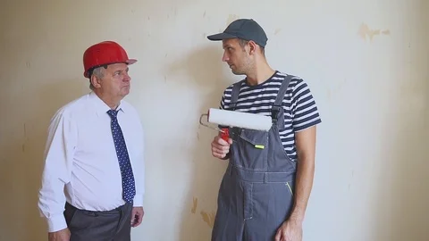 Senior engineer and a young worker having fun and dancing at a construction site Video stock 95329636
