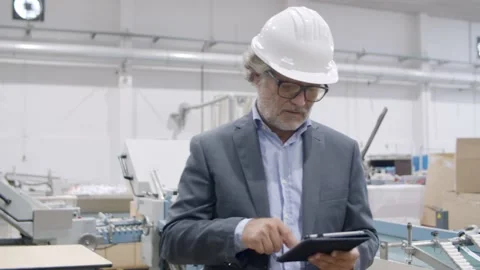 Senior engineer checking machinery work process Stock Footage 147500395
