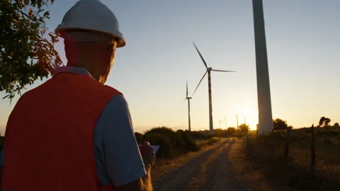 Senior Engineer checks the correct functioning of wind turbines with the sheet Video stock 260426296