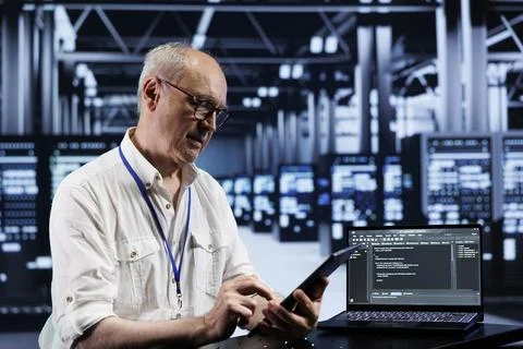 Senior engineer coding in data center 写真素材